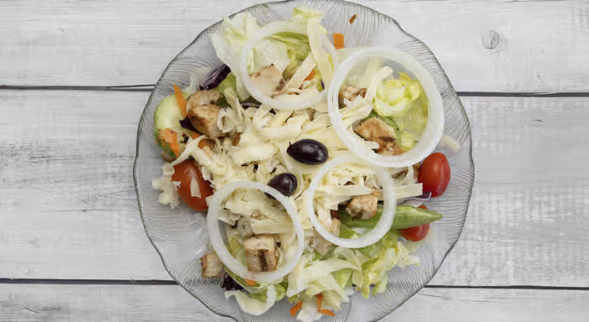 Salad with shredded chicken, black olives, tomatoes and onions