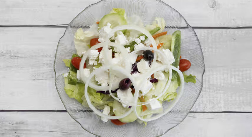 Salad with feta cheese, black olives, tomatoes and onions