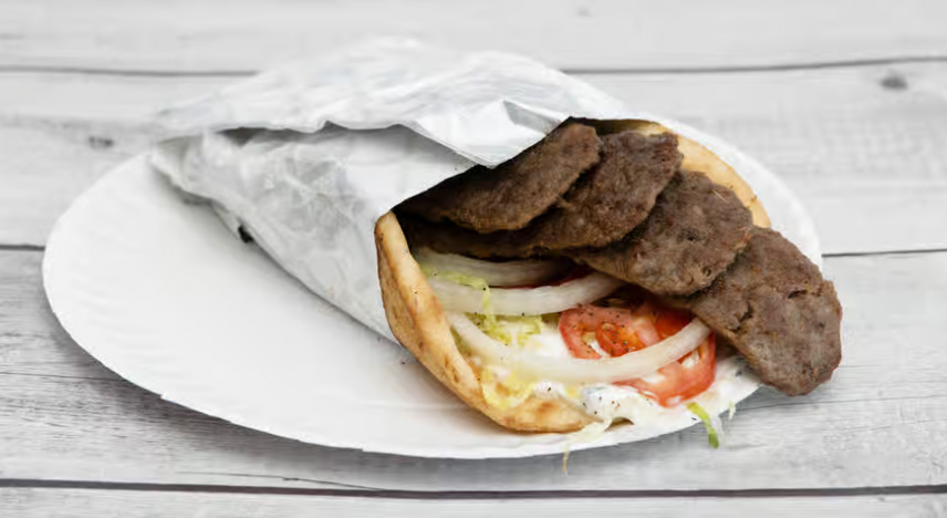 Gyro meat on pita bread wrapped in silver foil