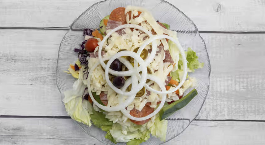 Salad with meat, cheese, black olives, tomatoes and onions